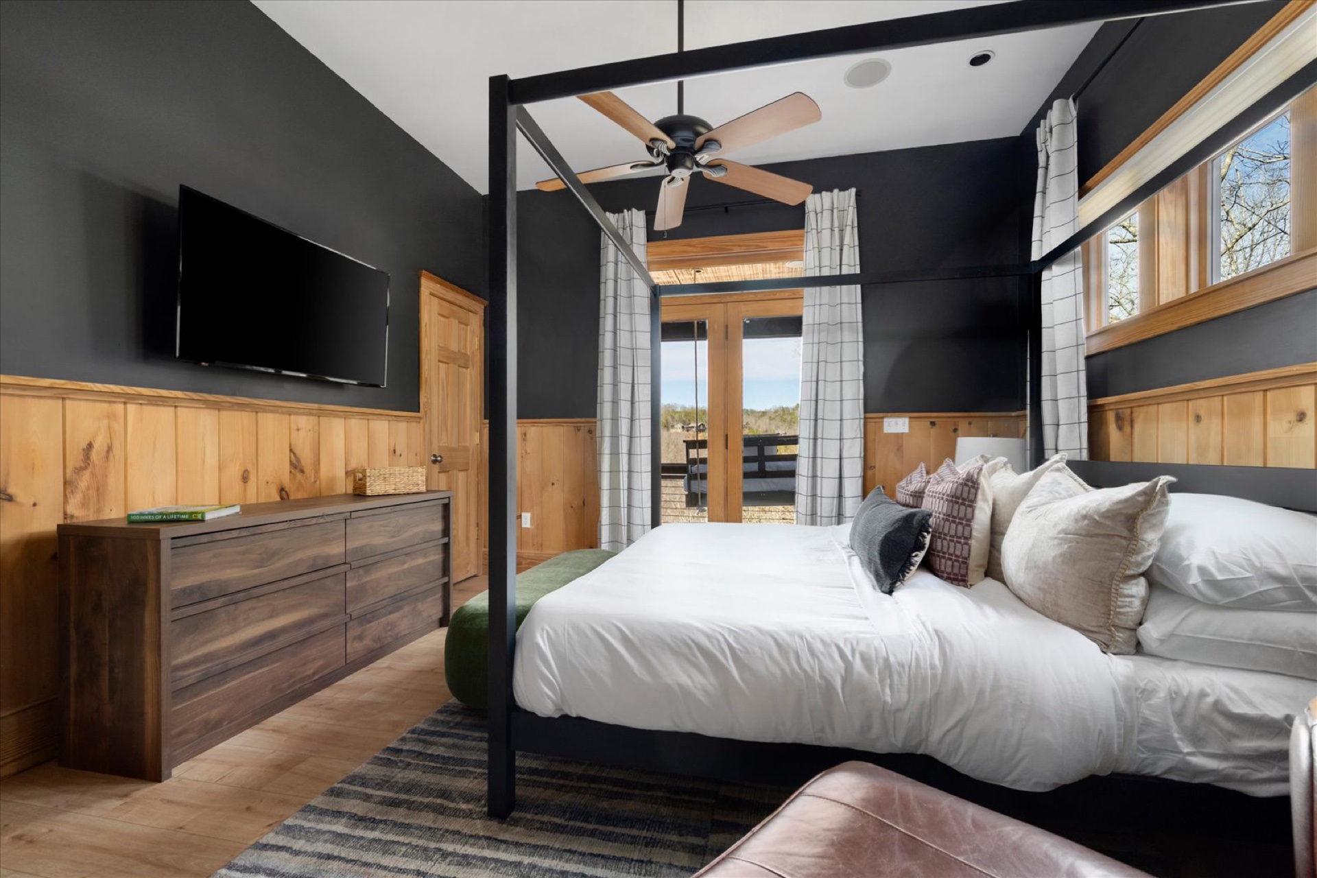 King Master Suite — dark walls, 4-poster king bed